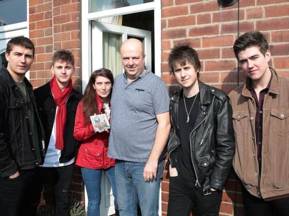 The Sherlocks Josh, Kiaran, Brandon and Andy with home owners Julie Coxhead and Richard Cannings. Photo: Glenn Ashley