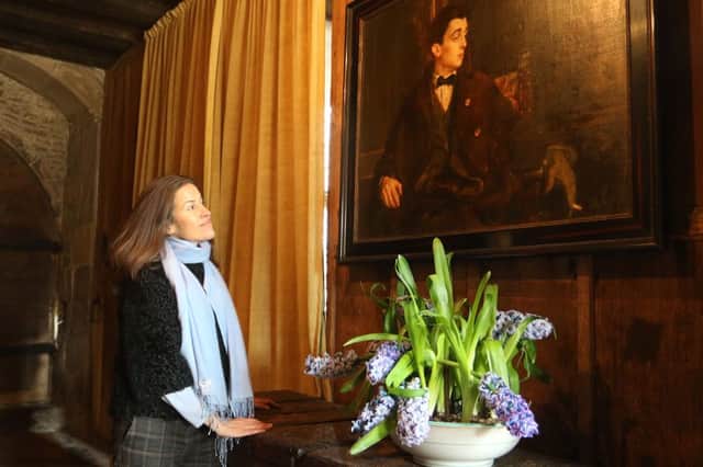 Lady Edward Manners with the portrait of the 9th Duke who began the restoration of the hall into a family home