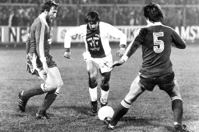 Johan Cruyff takes on the Bayern Munich defence at the Olympic Stadium in Amsterdam, where he made a special appearance for Ajax - his first club - in the final game of his career in 1978.