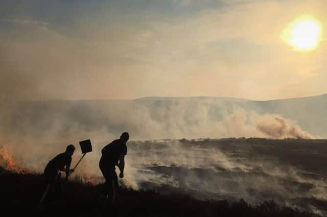 Fire crews tackle a fire high up in a remote part of the Peak District. Photo - George Smallwood/South Yorkshire