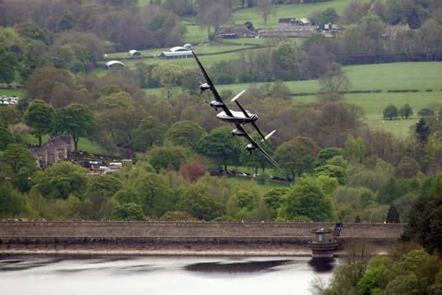 Britain's last remaining airworthy Lancaster makes a pass over the Derwent and Ladybower dams to celebrate the 70th anniversary of the famous dams raid in 2013.