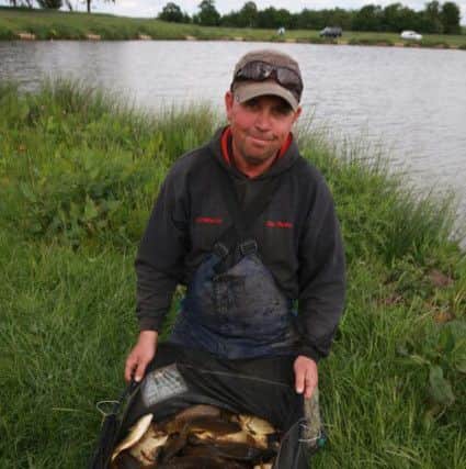 WEIGHING IN -- match ace Ken Parkes with a good net of big carp that he landed at Hayton Lakes Fishery, near Retford.