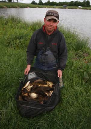 WEIGHING IN -- match ace Ken Parkes with a good net of big carp that he landed at Hayton Lakes Fishery, near Retford.