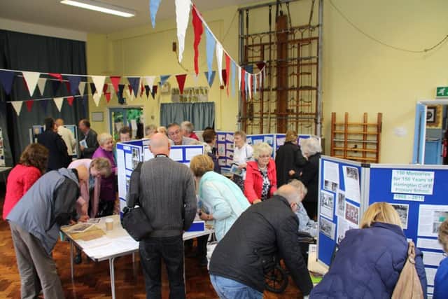 Guests enjoying the exhibitions in the school hall.