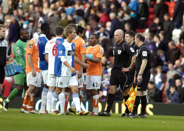 Blackburn Rovers v Blackpool - Football. Players surround referee Howard Webb at the final whistle.