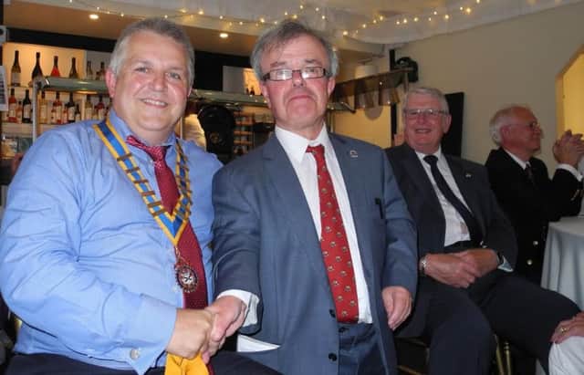 Kevin Smith, left, receiving his gong and being installed as the new president for Ilkeston Rotary, from immediate past president Chris Smith.