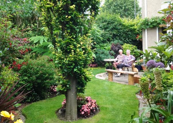 Richard and Sharon Smithson in their garden at 70 Hawksley Avenue, Newbold, Chesterfield.