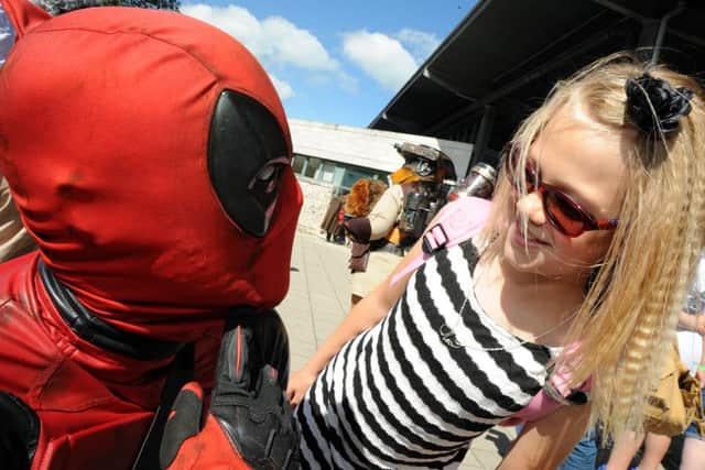 Nine-year-old Cleo Barrett gets some attention from Dead Pool.
