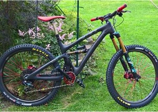 A black, red, and gold Yeti bike frame was stolen from a car in Glossop.