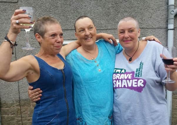 ALL FOR ONE AND ONE FOR ALL -- Tracey and her two friends after the sponsored head-shaves.