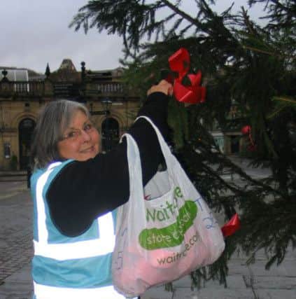 Director of the Town Team Tina Heathcote putting the finishing touches to one of teh town's Christmas trees