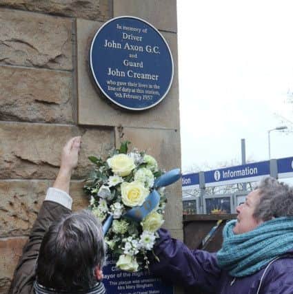 Marking the 60th anniversary of the Chapel rail disaster, Richard Bagot and Glenys Brooks of the Friends of Chapel Station place the wreath