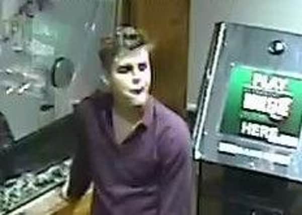Pictured is one of two men police would like to contact to help them with their enquiries after a coffee machine was damaged during an incident in a Chesterfield town centre taxi office.