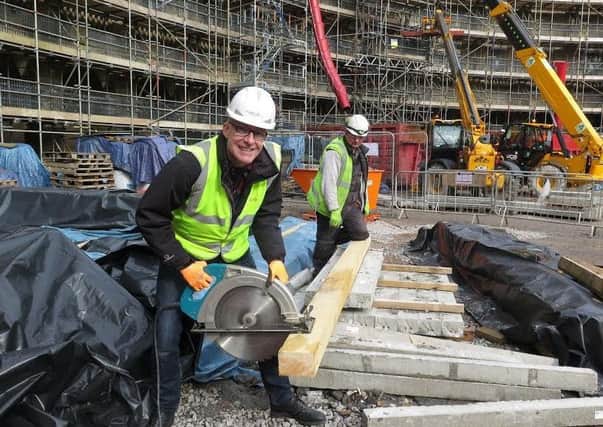 Buxton and Leek College Principal Len Tildsley swapped his mortar board for a hard hat to work on a building site for the day as part of National Apprenticeship Week.