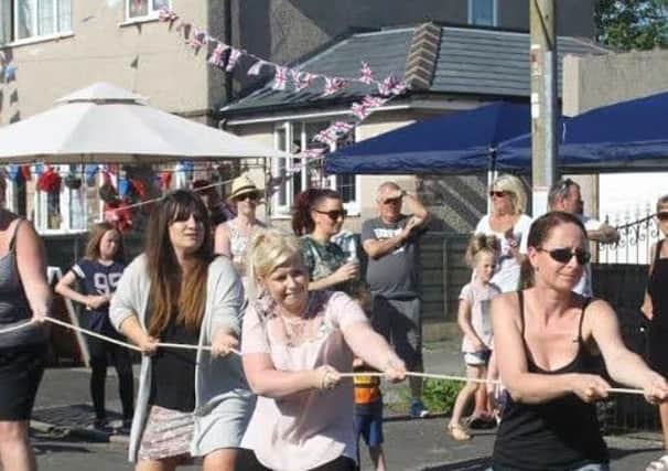 Residents of Lathkil Grove showing their strength in men v women tug of war at the Queen's birthday street party