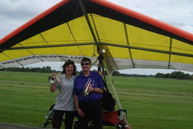 Helen Thurlby and Judy Leden performed Fly Me To The Moon on a cornet while hang gliding. Pictured just after landing.