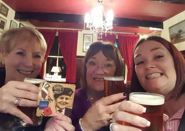 Hayfield poppy appeal organiser, Lynne Howell, with customers Cath and Caroline Rodgers at the launch of the new craft ale.