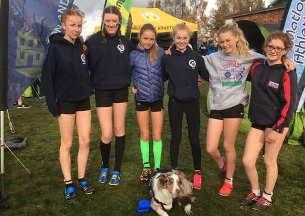 The Buxton AC Juniors' U15 girls' team with the club mascot, Jip the dog.