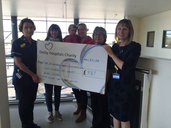 Louise Golden and  Laura Moseley presents proceeds from their participation in the Derby Hospitals Charity colour run.
