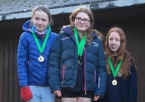 Three of the U15 girls with their gold medals for finishing top team.
