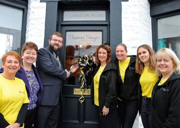 Councillor Matt Stone, the Mayor of Buxton, cuts the ribbon to officially open the Thomas Theyer charity shop on London Road on Saturday morning, with from left, Angela Crawford, Lynne Stone, Chris Theyer, Sharon Stanley, Aimee Theyer and shop manager Mararet Swift.