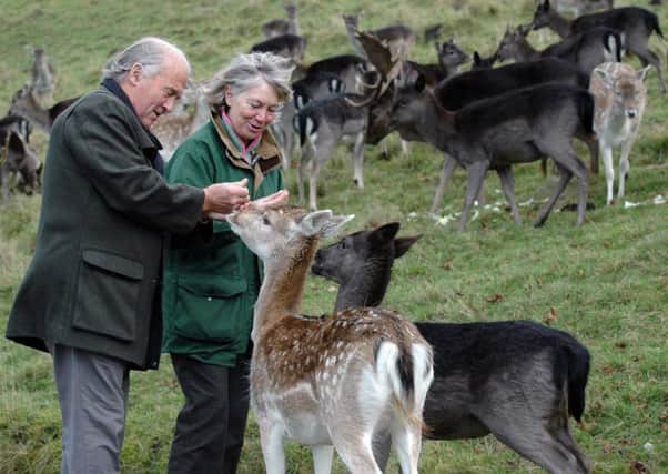 Carol and Roger Heap, pictured in 2013 with the Chestnut Centre's deer herd.