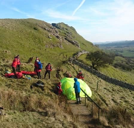 Buxton Mountain Rescue Team preparing the stretcher at the casualty site with Chrome Hill in the background.
