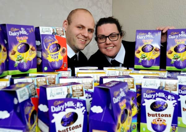 James and Emma Howe from J.T.Howe Funerals pictured with the haul of Easter eggs they have collected for hospitalised children.