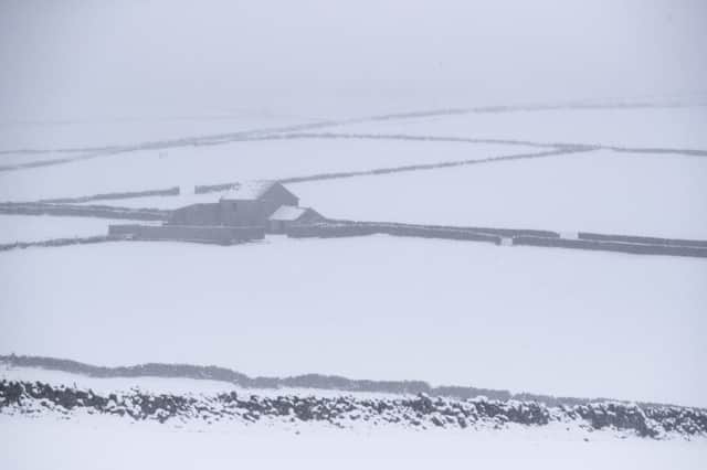 Looking more like 'The Bleak District' rather than The Peak District, snow and mist shroud fields near Peak Forest in Derbyshire.