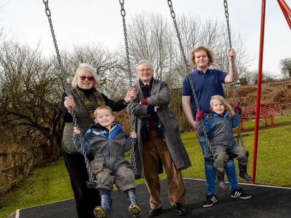 Four-year-olds Benjamin Chesworth and Keira Davis enjoy the swings with councillors Emily Thrane, John Pritchard and Andrew Fox.