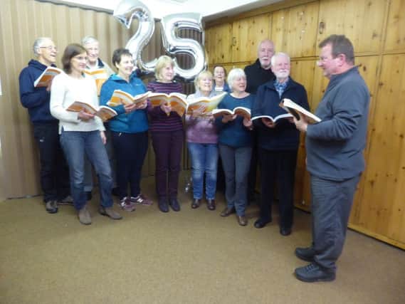 From left to right, some choir members who have been with Hayfield Singers since its launch 25 years ago: Peter Edgerton, Mary Edgerton, Jim Mason, Pennie Roberts (chair), Joan Bond, Sue Colston, Lesley Mason, Christine Moore, Roger Briscoe (associate musical director), Peter Bowes and Simon Mercer (musical director).