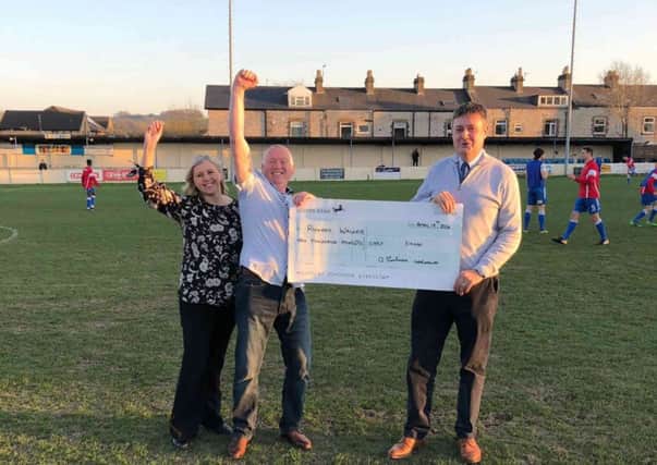 Richard Walker and his wife, receiving the winning cheque from Buxton FC Chairman, David Hopkins