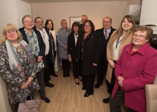 Councillors and project partners who have all backed the Thomas Fields Extra Care development for older people look around at the finished show home.