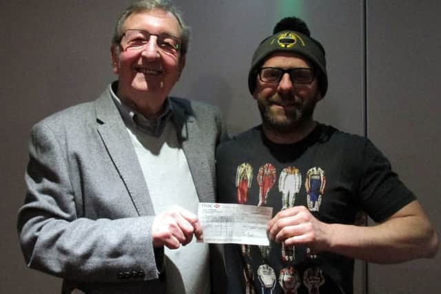 Frank Hambleton, Chairman of Buxton Motorbikes Club, receives a cheque for Â£550 from David Glossop.