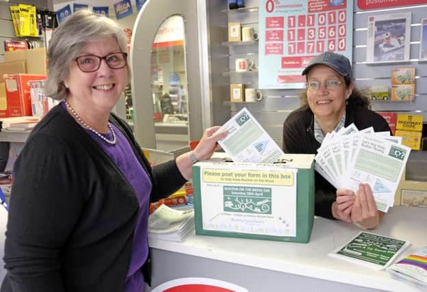 Town Team member Tina Heathcote posts her travel survey at Higher Buxton Post office with fellow member Janet Miller